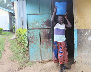 cynthia carrying water from the pump